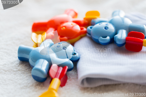 Image of close up of baby rattle and clothes for newborn