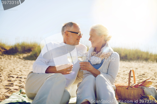 Image of happy senior couple talking on summer beach