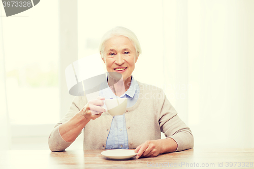 Image of happy senior woman with cup of coffee