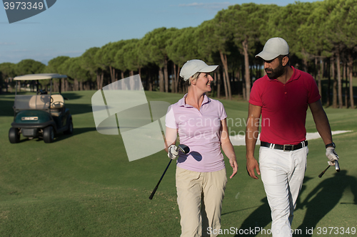 Image of couple walking on golf course