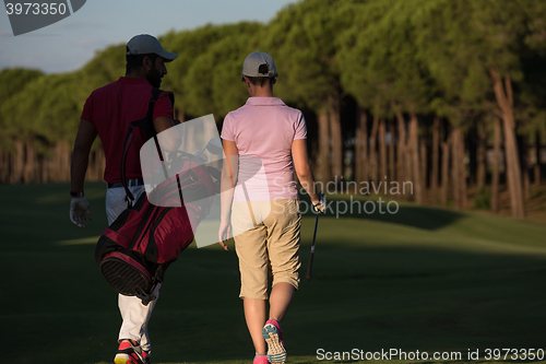 Image of couple walking on golf course