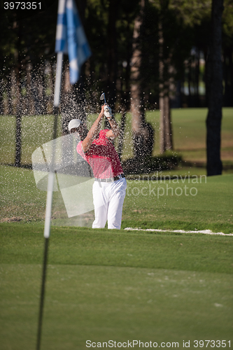 Image of golfer hitting a sand bunker shot