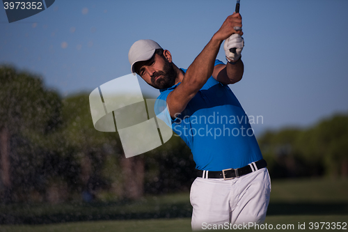 Image of pro golfer hitting a sand bunker shot