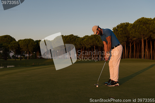 Image of golfer  hitting shot at golf course