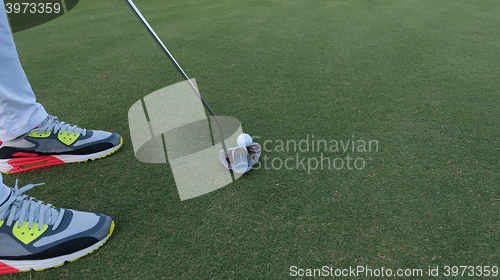 Image of hitting golf ball to hole