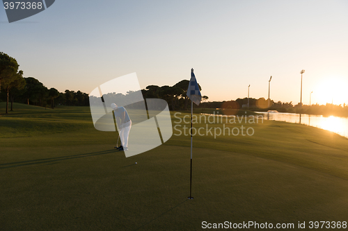 Image of golfer hitting ball to hole