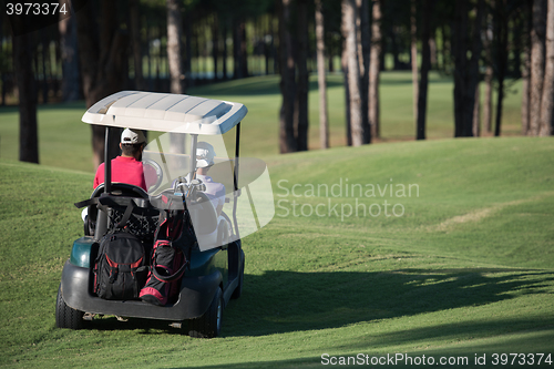 Image of couple in buggy on golf course