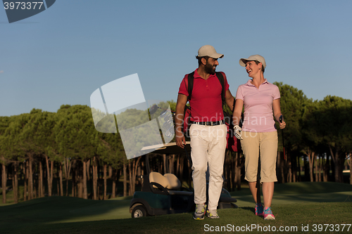 Image of couple walking on golf course