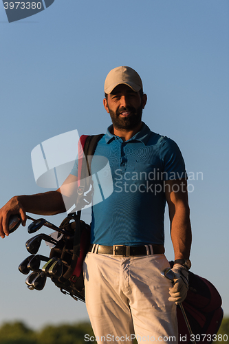Image of golfer  portrait at golf course on sunset