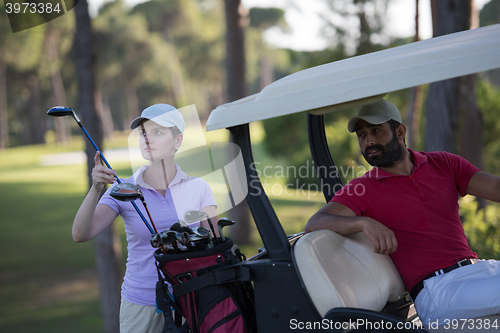 Image of couple in buggy on golf course