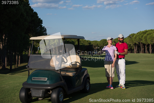 Image of couple in buggy on golf course