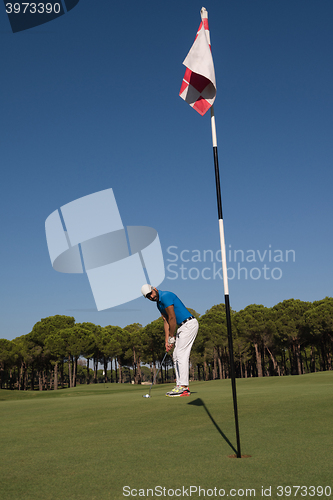 Image of golf player hitting shot at sunny day