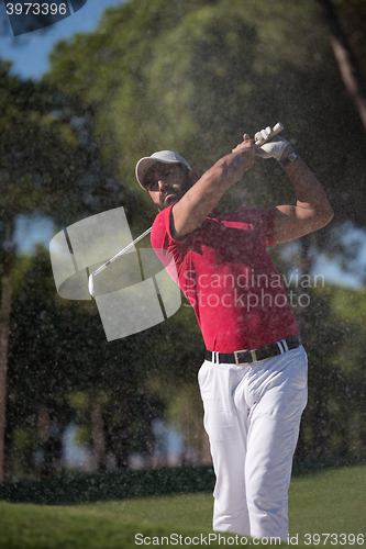 Image of golfer hitting a sand bunker shot