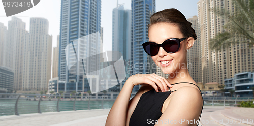 Image of beautiful young woman in elegant black sunglasses