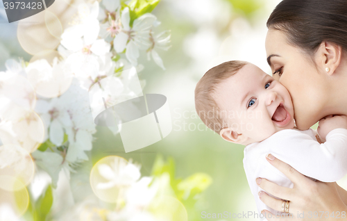 Image of happy mother kissing adorable baby