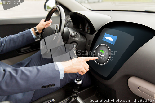 Image of close up of man in car with starter on computer