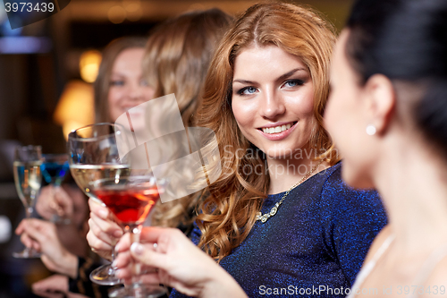 Image of happy women with drinks at night club