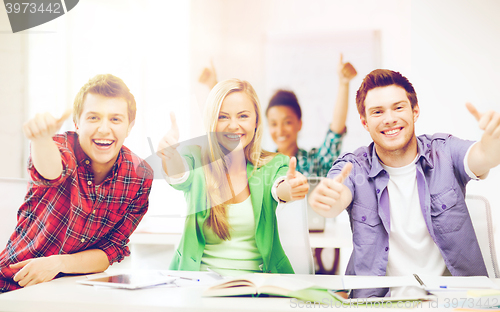 Image of students showing thumbs up at school