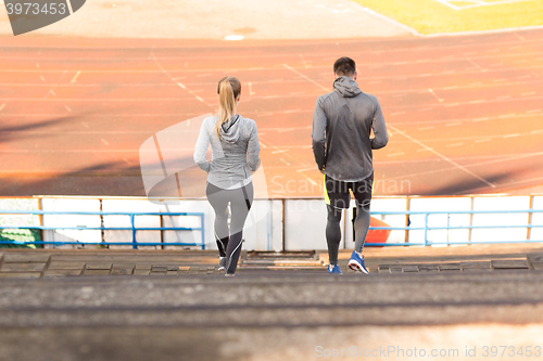 Image of couple running downstairs on stadium