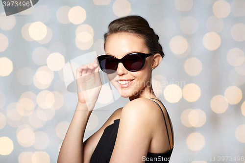 Image of beautiful young woman in elegant black sunglasses