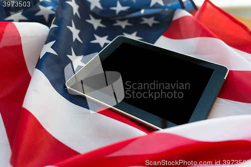 Image of close up of tablet pc computer on american flag