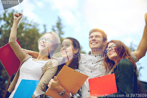 Image of group of happy students showing triumph gesture