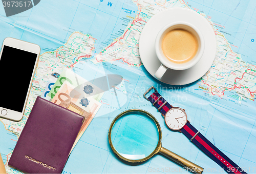 Image of Preparation for travel concept - map, magnifying glass, cup of coffee, notepad, phone