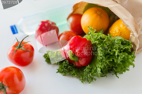 Image of basket of fresh vegetables and water at kitchen