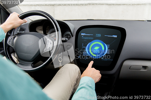 Image of man driving car with eco mode on board computer