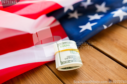 Image of close up of american flag and dollar cash money