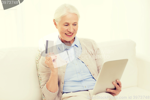 Image of senior woman with tablet pc and credit card