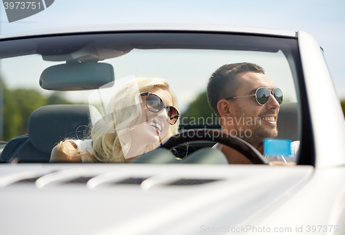 Image of happy man and woman driving in cabriolet car