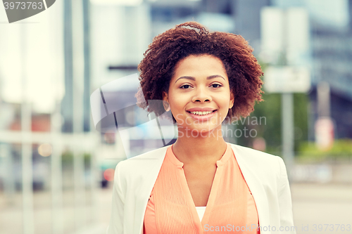Image of happy young african american businesswoman in city