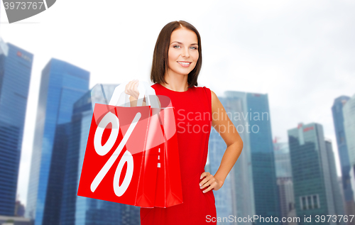 Image of happy woman with shopping bags over singapore city