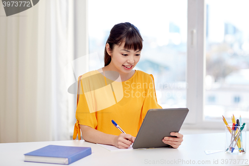 Image of asian woman student with tablet pc at home