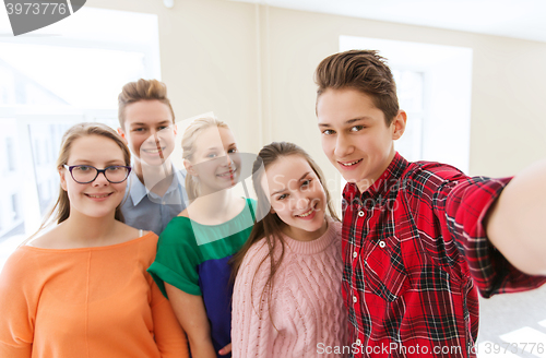 Image of group of students taking selfie with smartphone