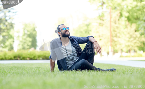 Image of man in sunglasses at city street or park