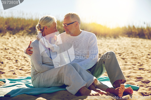 Image of happy senior couple hugging on summer beach