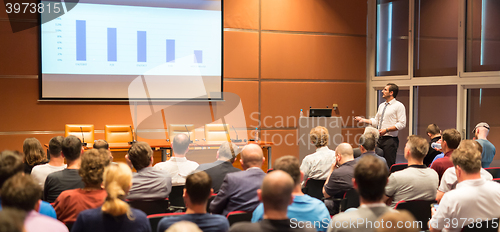 Image of Business speaker giving a talk in conference hall.