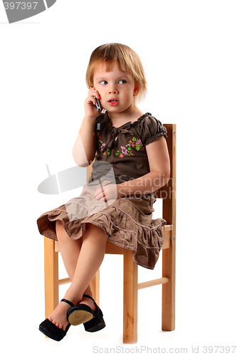 Image of Pretty girl in big shoes talking by phone.