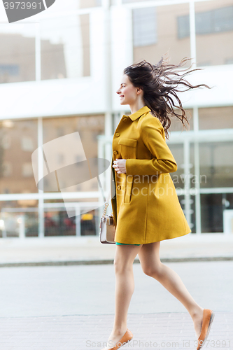 Image of happy young woman or teenage girl on city street