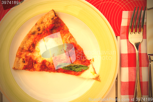 Image of margarita pizza with basil on a plate