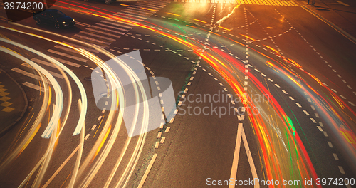 Image of crossroads with traces lights of cars at night