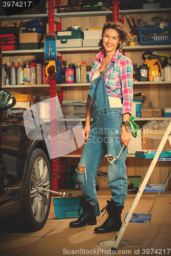 Image of Full length portrait of a smiling female mechanic