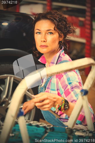 Image of Portrait of a woman mechanic in overalls