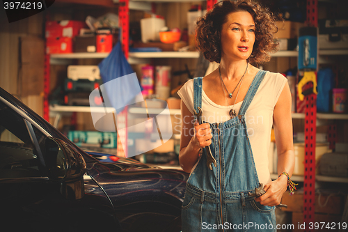 Image of woman mechanic with a wrench in his hand