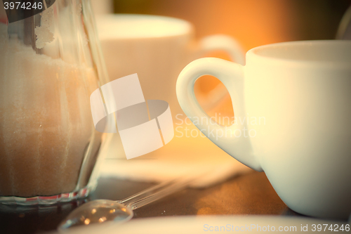 Image of cup with tea, spoon and sugar