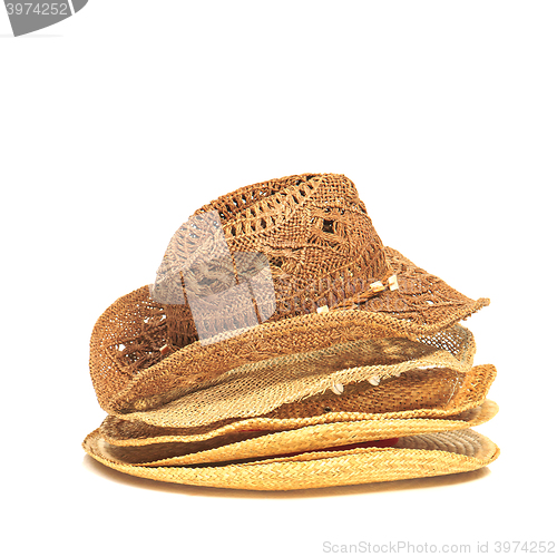 Image of The lot of straw hats isolated on white background.