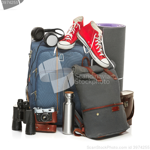 Image of The suitcases, sneakers, retro camera, karrimat and binoculars on white background.
