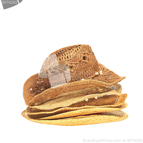 Image of The lot of straw hats isolated on white background.